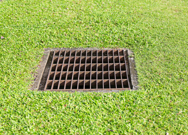 istock Drainage steel grate installed in the green lawn area 2155536618