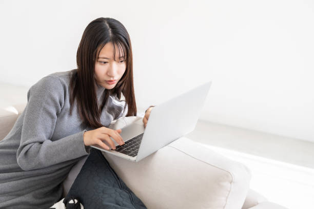 istock young asian woman using laptop 2155537883