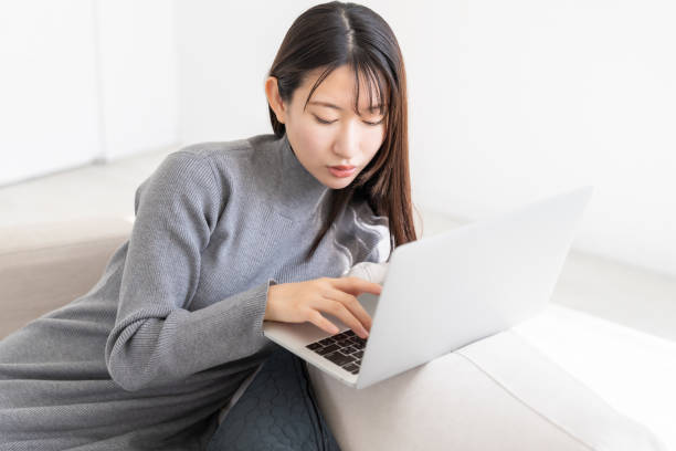 istock young asian woman using laptop 2155537938