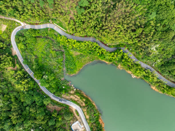 istock Winding mountain road with green forest overlooking 2155540007