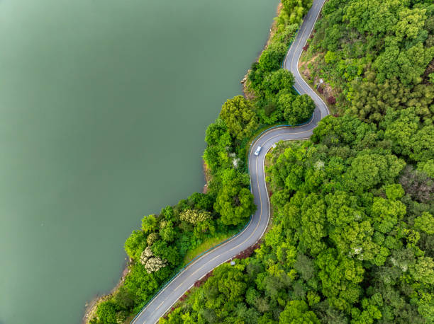 istock Winding mountain road with green forest overlooking 2155540102