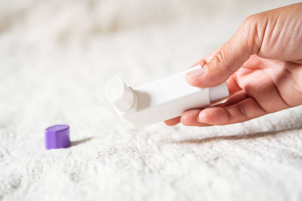 istock Woman holding asthma inhaler applying for prevent asthma attack. 2155541389