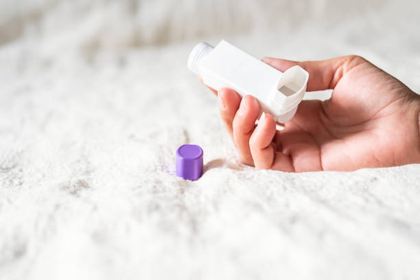 istock Woman holding asthma inhaler applying for prevent asthma attack. 2155541390