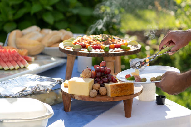 istock Person taking food at a outdoors party 2155542061