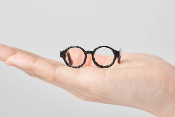 istock A model of glasses resting on a woman's palm 2155545883