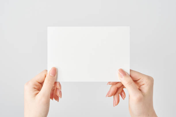 istock A woman's hands holding a blank paper in both hands 2155545928