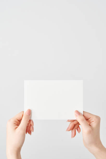 istock A woman's hands holding a blank paper in both hands 2155545932