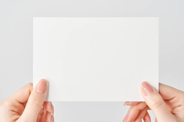 istock A woman's hands holding a blank paper in both hands 2155545937