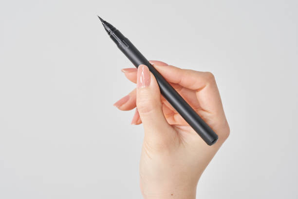 istock Woman's hand holding a brush pen 2155546076