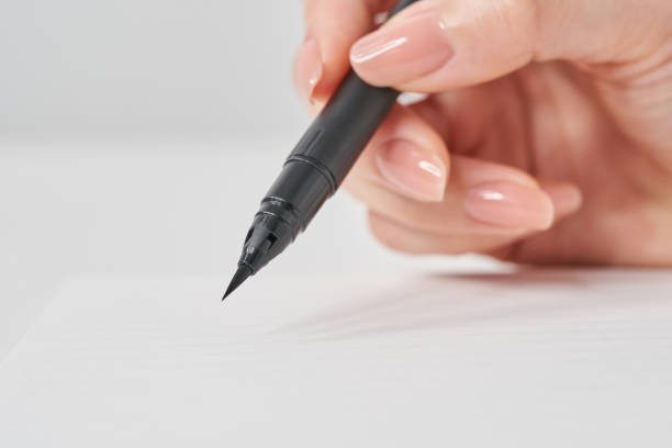 istock Woman's hand holding a brush pen 2155546086