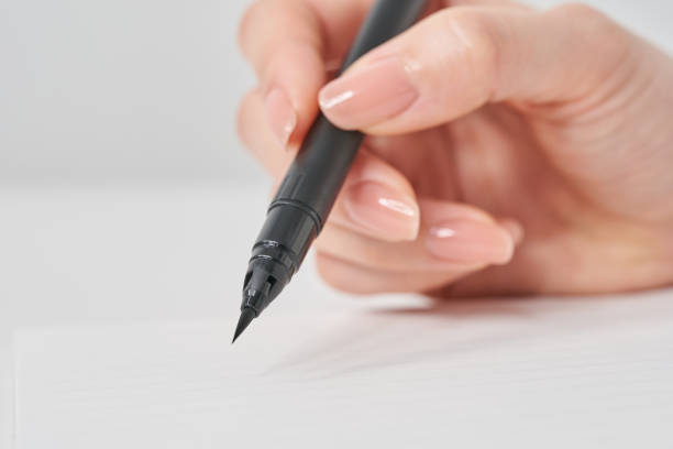 istock Woman's hand holding a brush pen 2155546096
