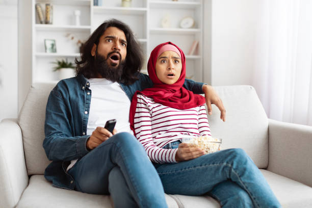 istock Couple Reacts With Shock and Surprise While Watching Television 2155546394