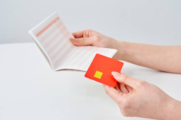 istock A woman's hand holding a bank passbook and card 2155546399