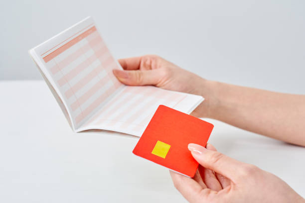 istock A woman's hand holding a bank passbook and card 2155546417