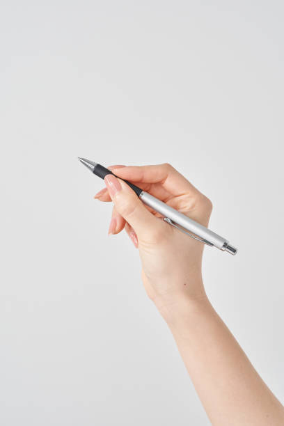 istock female hand holding black ballpoint pen 2155546461
