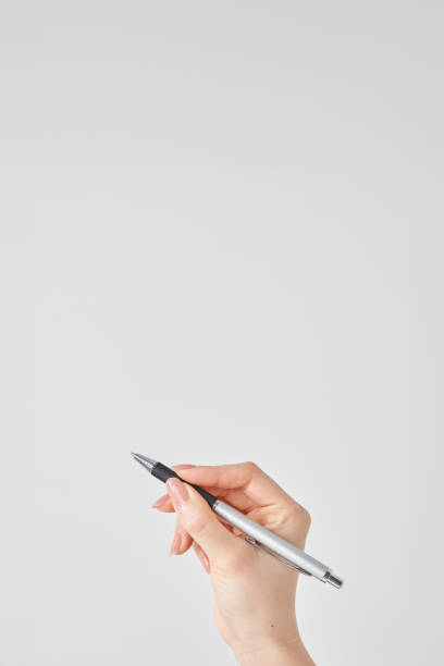 istock female hand holding black ballpoint pen 2155546489