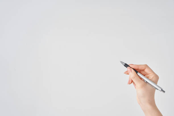 istock female hand holding black ballpoint pen 2155546539