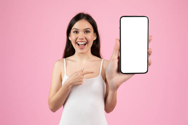 istock Woman pointing at smartphone with blank screen 2155546712