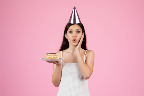 istock Surprised lady with birthday cake on a plate 2155546740