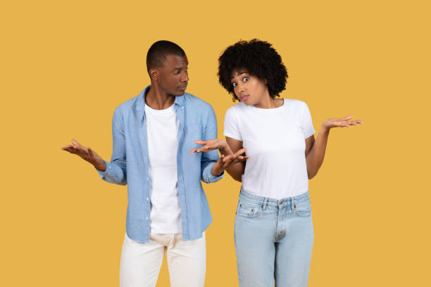 istock Couple expressing confusion and indecision on yellow 2155546802