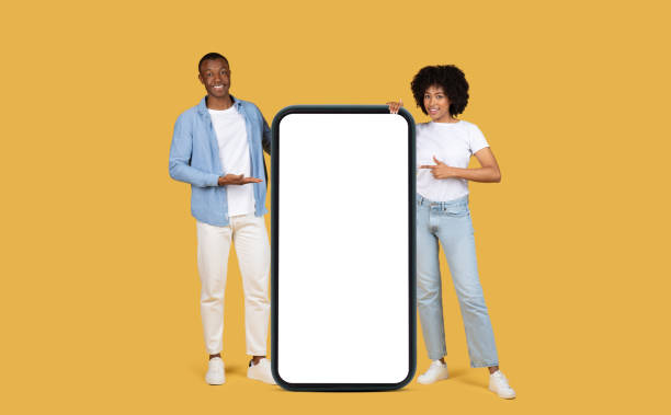 istock Engaging African American couple presenting a large vertical blank smartphone screen 2155546975