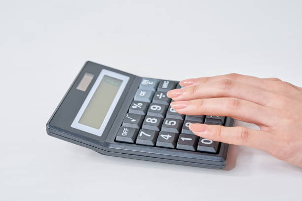 istock Hand of a woman using a calculator 2155547183