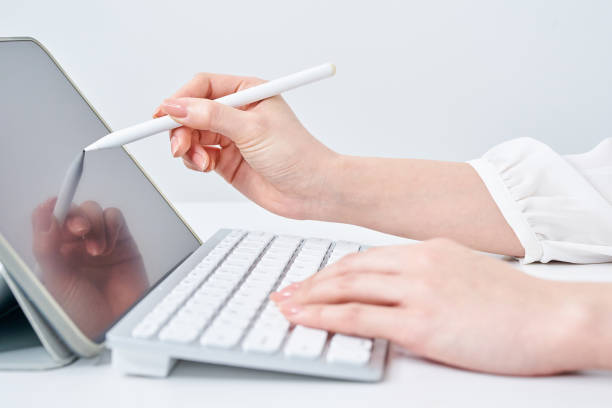 istock Hands of a woman operating a tablet PC 2155547240