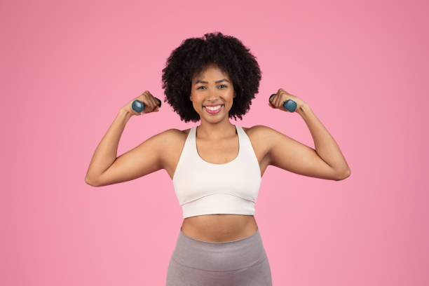 istock Smiling woman exercising with dumbbells 2155547280