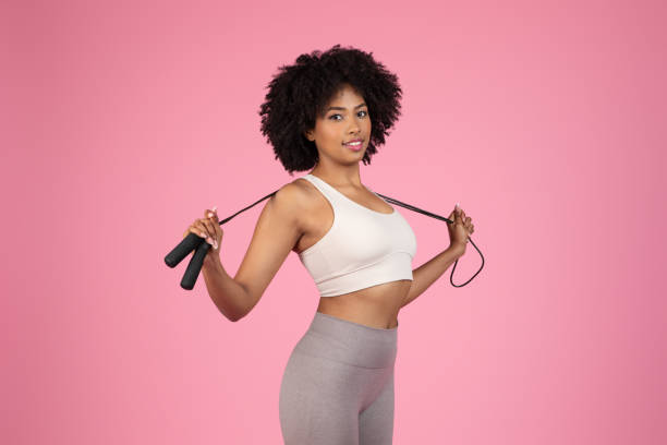 Woman holding a jump rope behind her back
