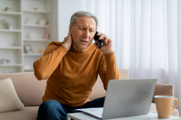 istock Stressed elderly businessman have phone conversation, working from home 2155547404