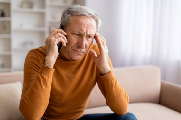 istock Distressed senior man have phone conversation at home, copy space 2155547427
