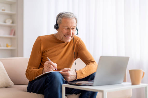 istock Excited senior man attending webinar at home 2155547445