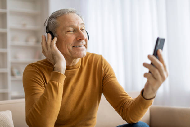 istock Man video calling and gesturing happiness at home 2155547477