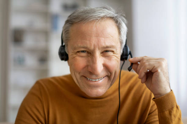 istock Senior man with headphones have video call 2155547493