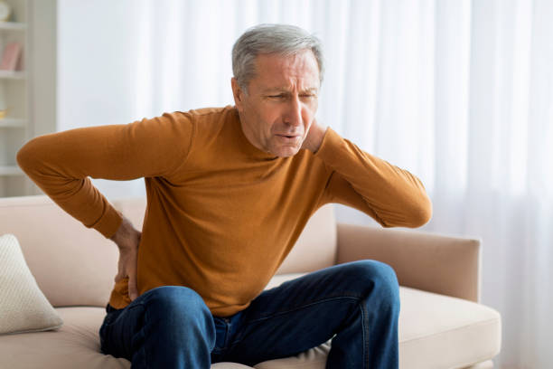 istock Upset senior elderly man feel sudden back pain, home interior 2155547561