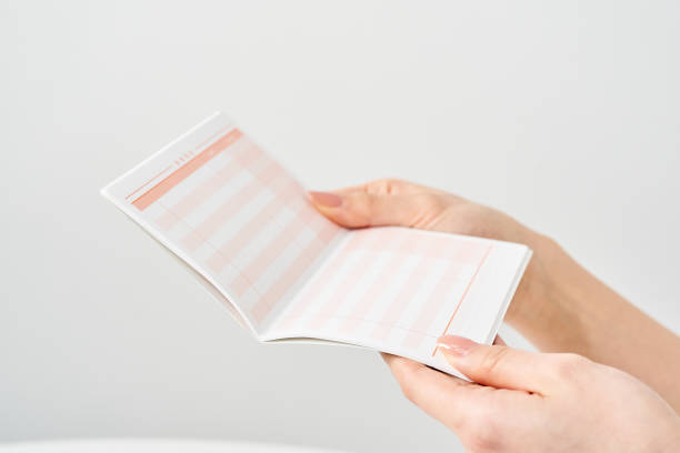 istock Woman's hand looking at bank passbook 2155547672