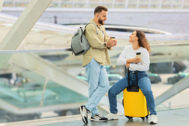 istock Happy Young Couple Having Fun While Waiting Flight At Airport 2155547717