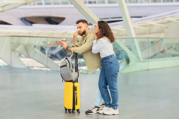istock Couple with suitcase at a modern station, late on flight 2155547781