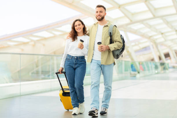 istock Couple strolling with a yellow suitcase 2155547795