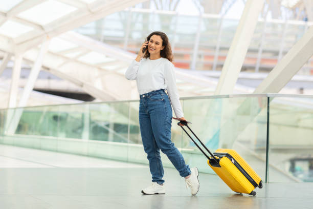 istock Traveler speaking on the phone and walking 2155547796