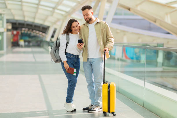 istock Happy couple strolling with a smartphone 2155547801