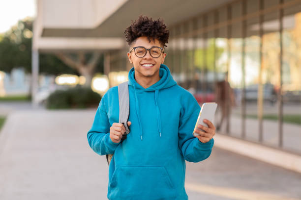 istock Young person holding phone and smiling 2155547862