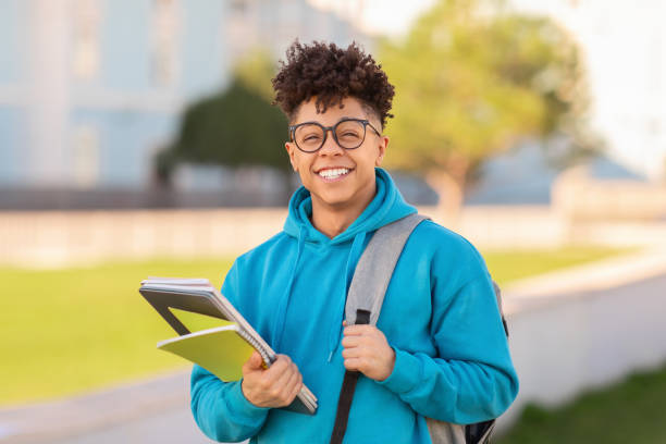 istock Portrait of smiling student guy posing with backpack and workbooks 2155547911