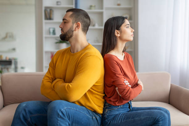 istock Couple sitting back-to-back looking upset 2155548024
