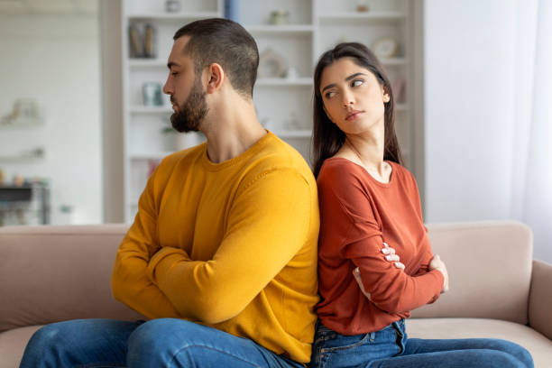 istock Couple in conflict sitting back to back 2155548047