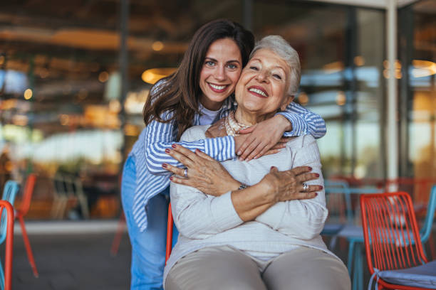 istock Affectionate Embrace Between Elderly Mother and Daughter in Store 2155550072