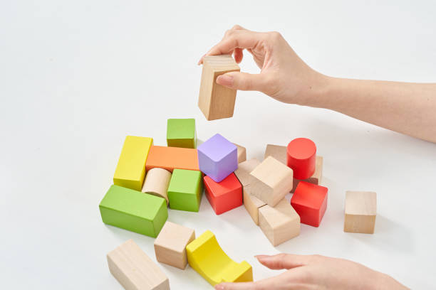 istock Hands of a woman stacking wooden blocks 2155552490