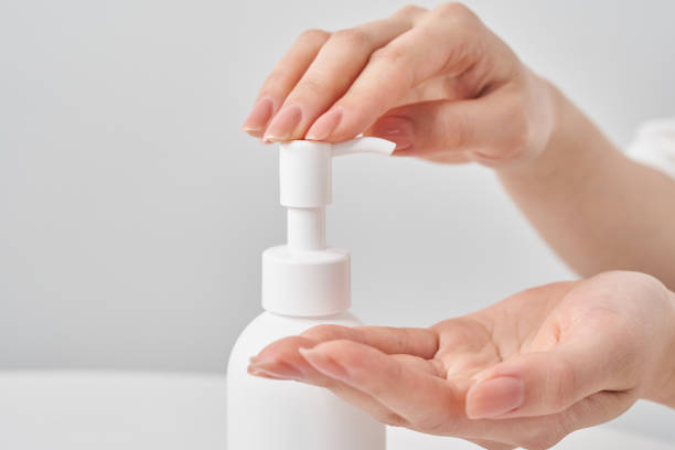 istock white bottle and woman's hand 2155552543