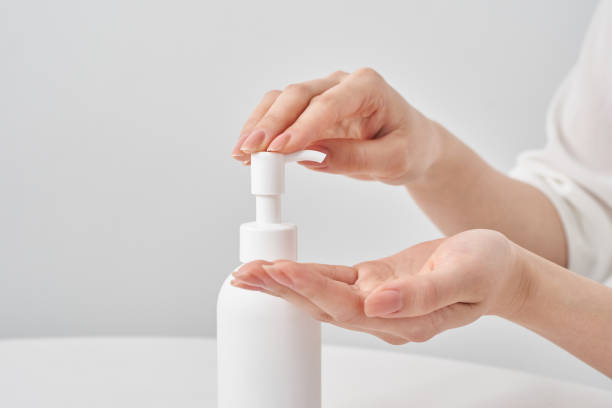 istock white bottle and woman's hand 2155552550