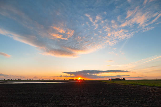 istock Setting sun over the wide open Dutch countryside 2155557037